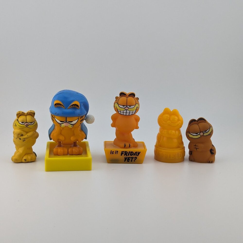 Bundle of 5 Vintage Garfield Collectibles: Toys, Stamps, and Pencil Topper